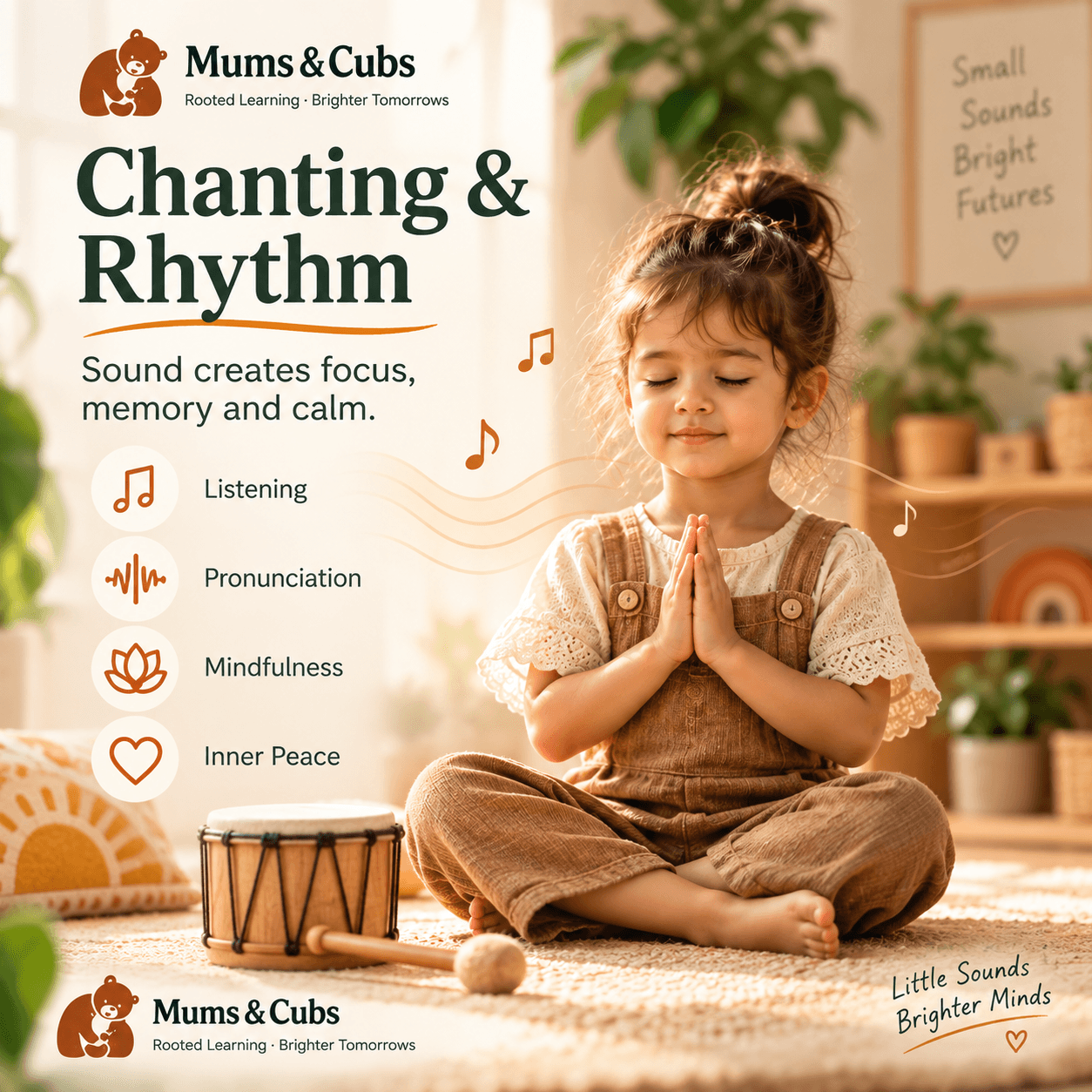 A child sitting calmly with a hand drum, hands in namaste.